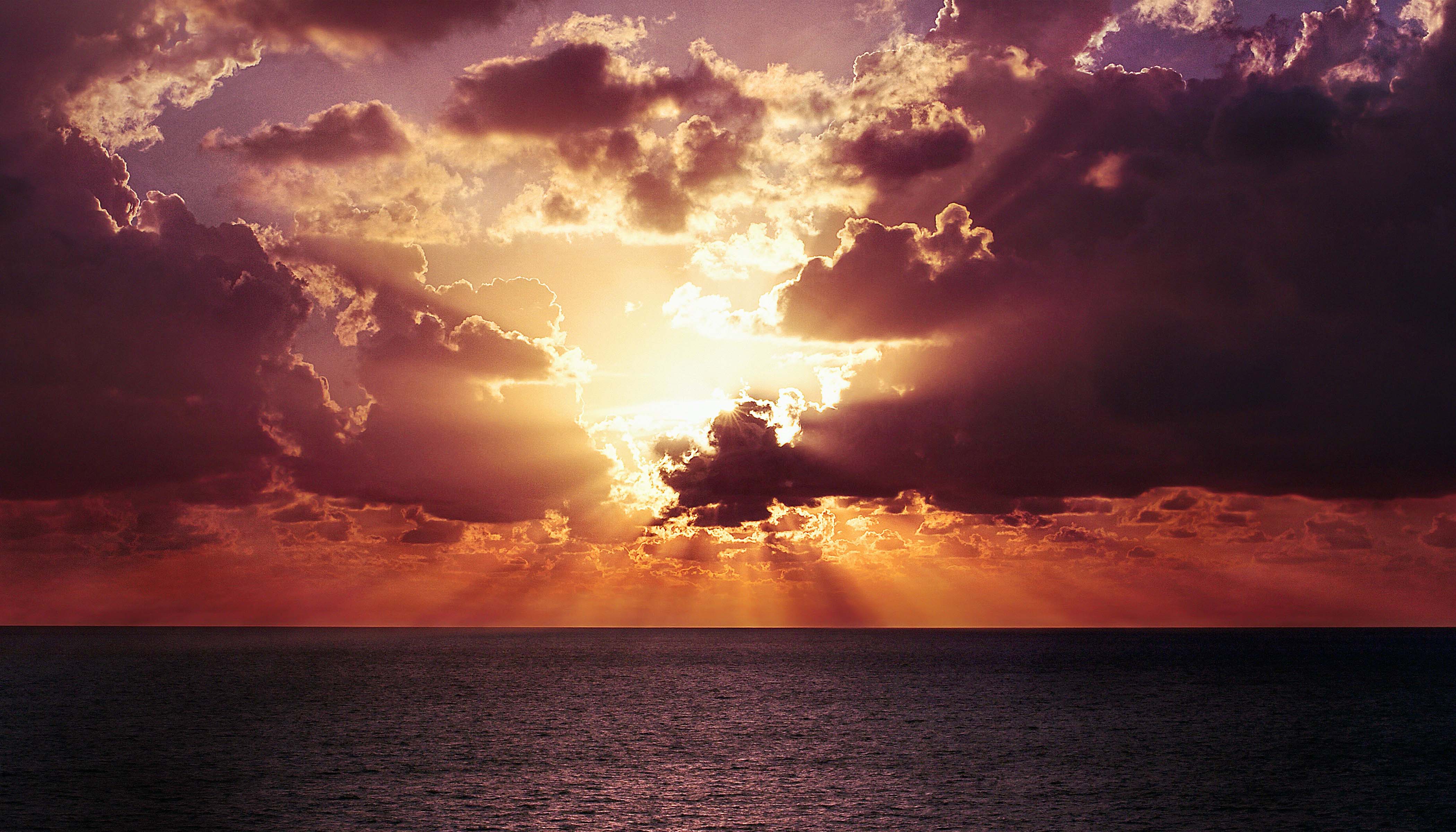 An Orange and Purple Sunset With Clouds