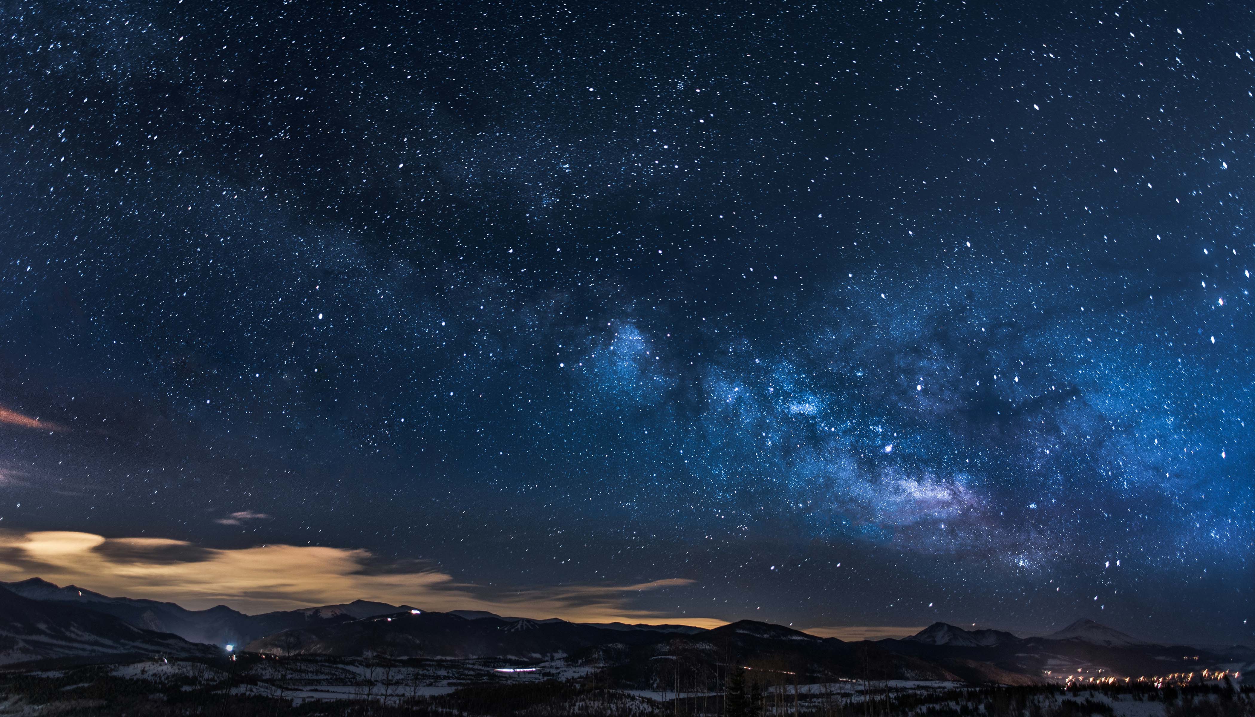 A Starry Sky With Mountains and Trees